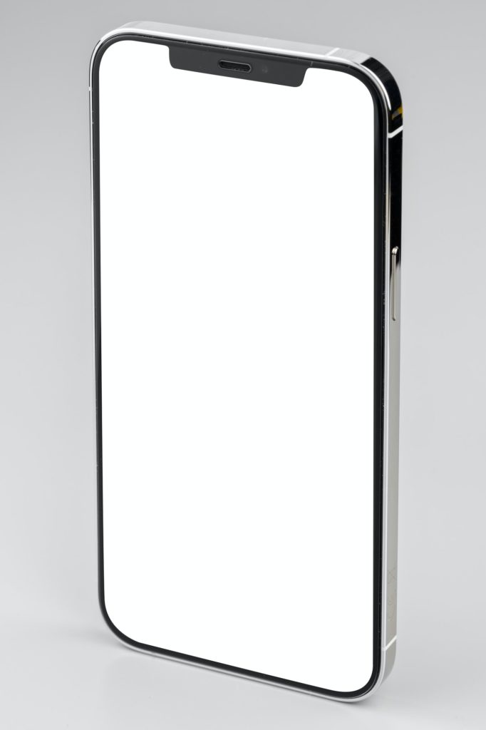Modern smartphone with white screen on gray background